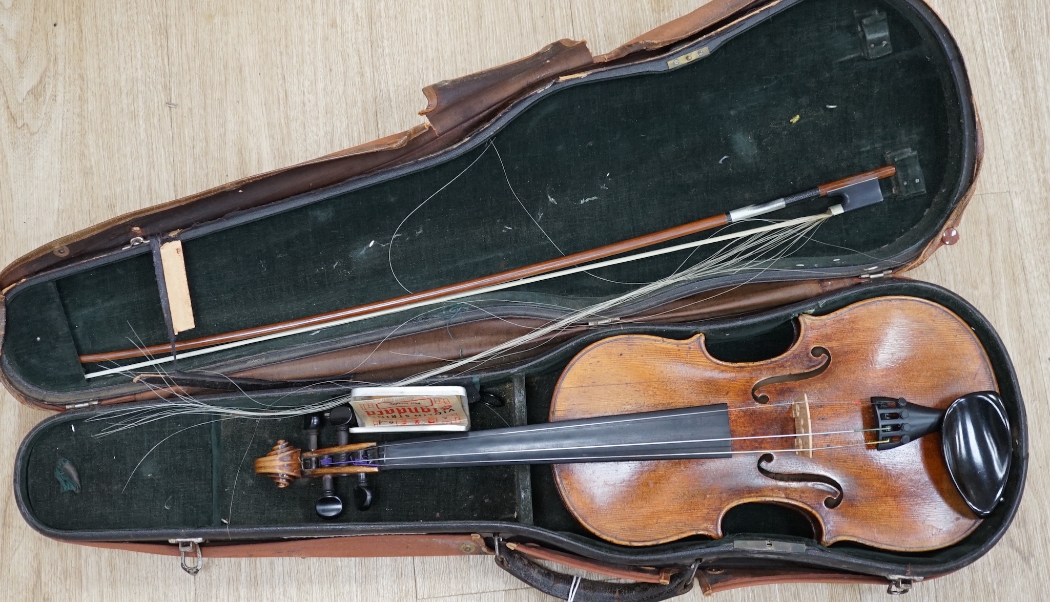 A cased 19th century German violin with paper label for Schweitzer copy Amati Pestini, length of body, 36cm, with bow CITES Submission reference 97BD7MYU